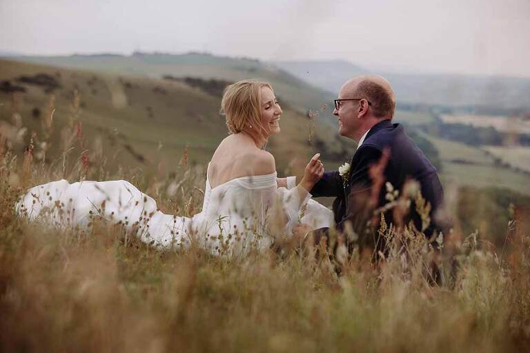 Bride and Groom in the grass during their Devils Dyke Farm wedding